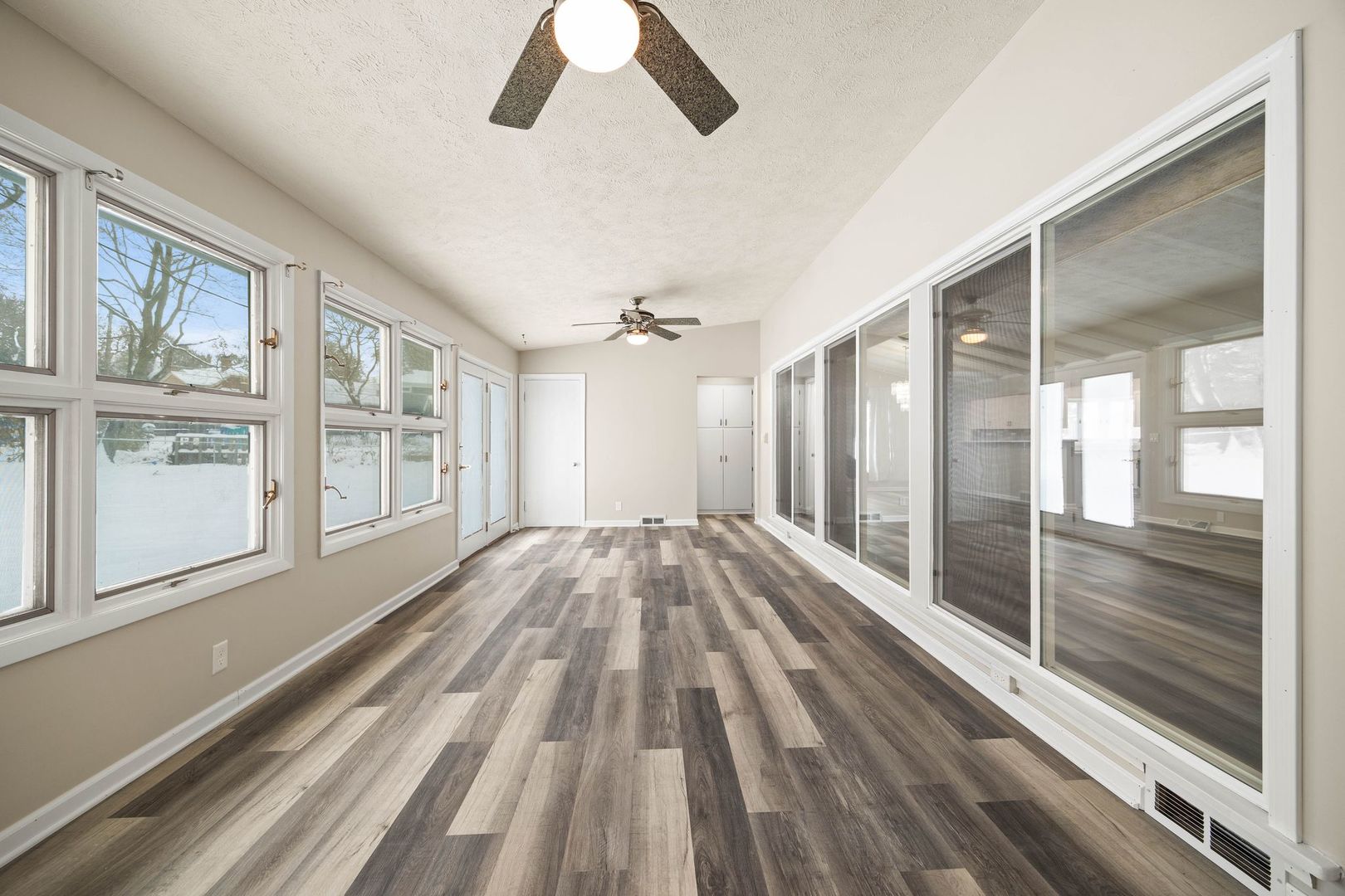 246 Miller Avenue DeKalb, IL 60115 - Photo 9 of 36 a view of empty room with wooden floor and fan