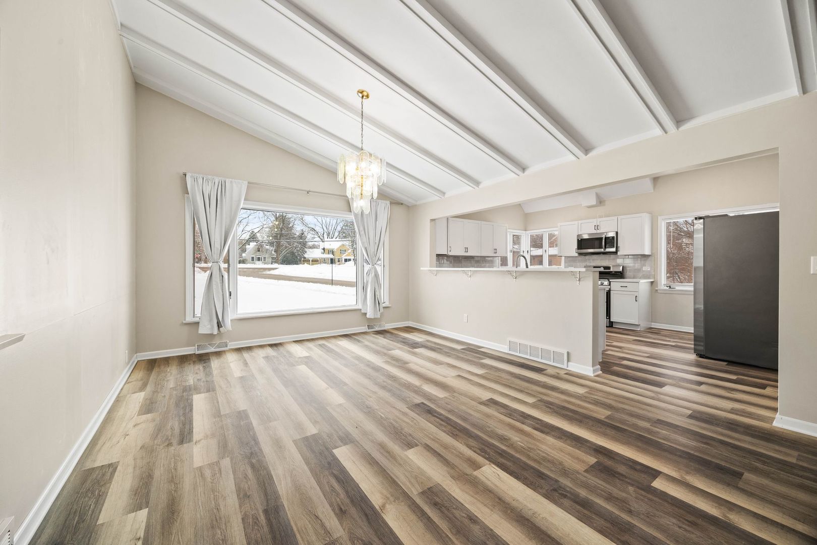 246 Miller Avenue DeKalb, IL 60115 - Photo 10 of 36 a view of a kitchen with wooden floor and refrigerator