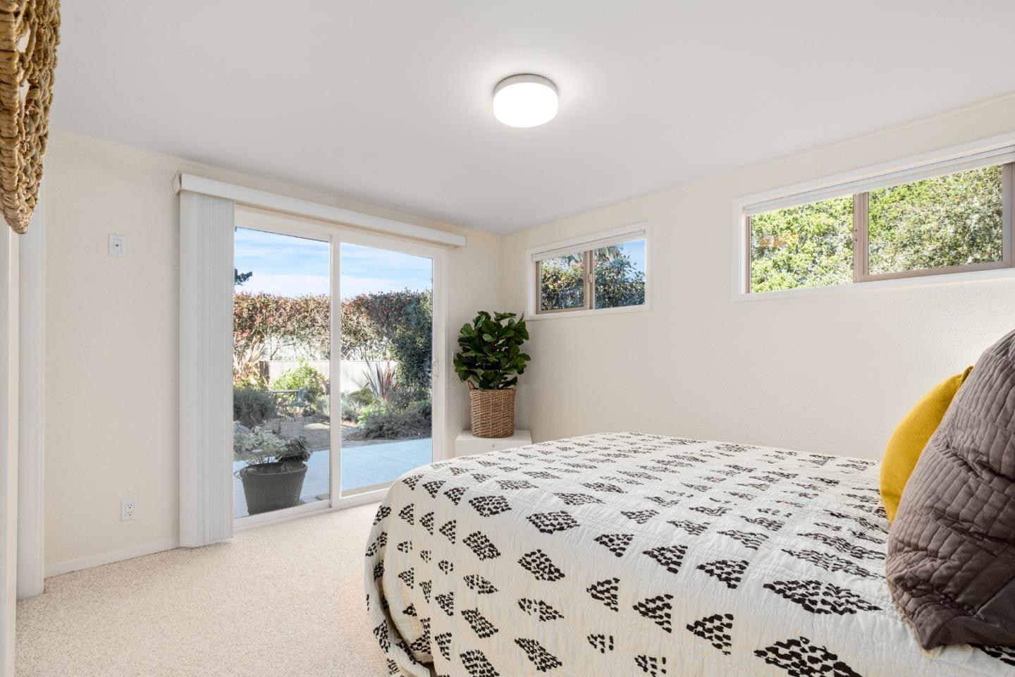 404 Arbolado Drive La Selva Beach, CA 95076 - Photo 14 of 36 a bedroom with a bed and a large window