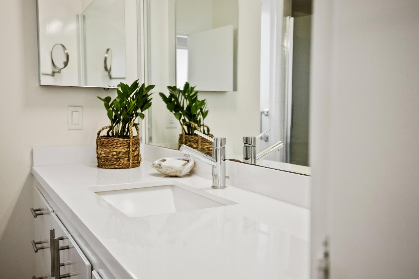 404 Arbolado Drive La Selva Beach, CA 95076 - Photo 15 of 36 a bathroom with a sink a mirror and a potted plant