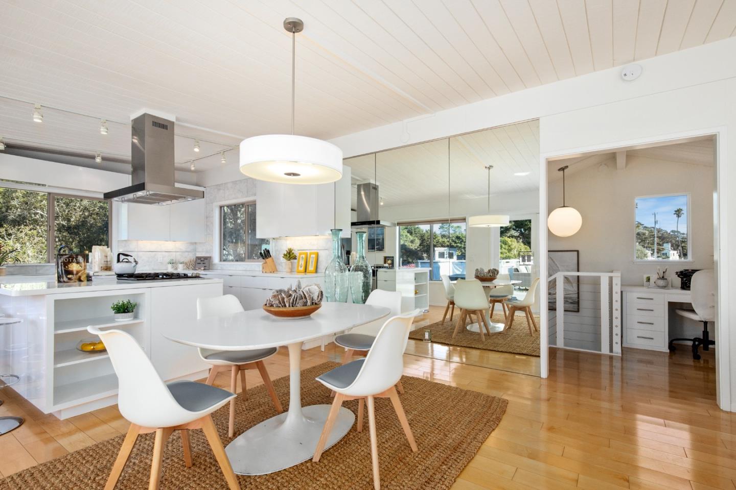 404 Arbolado Drive La Selva Beach, CA 95076 - Photo 35 of 36 a dining room with wooden floor a chandelier a wooden table and chairs