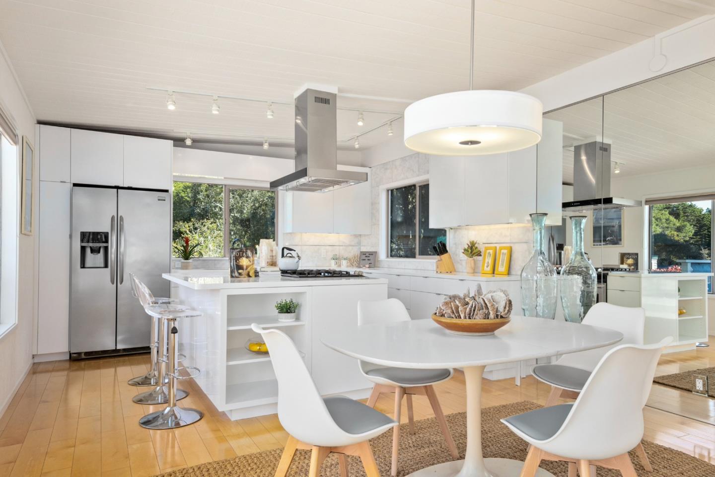 404 Arbolado Drive La Selva Beach, CA 95076 - Photo 9 of 36 a view of a dining room with furniture a chandelier and wooden floor