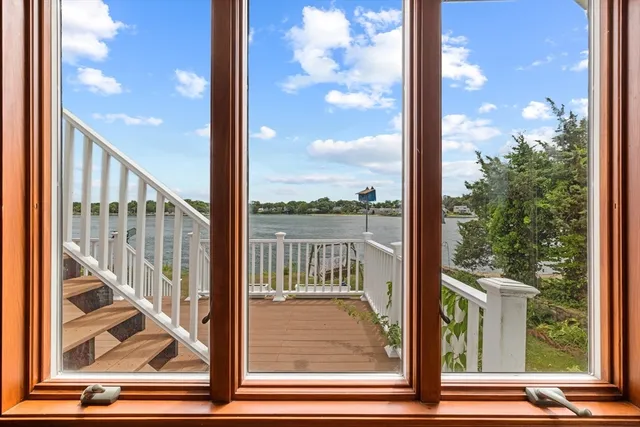 a view of empty room with wooden floor and fireplace
