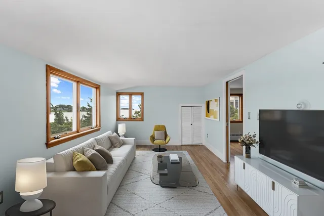 a view of a kitchen with refrigerator and wooden floor