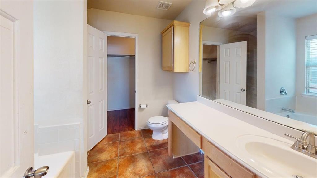 3251 Torio Grand Prairie, TX 75054 - Photo 18 of 23 a bathroom with a sink a toilet and shower
