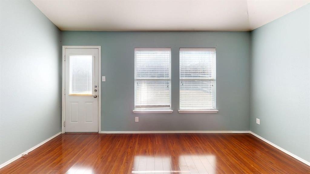 3251 Torio Grand Prairie, TX 75054 - Photo 7 of 23 an empty room with wooden floor and windows