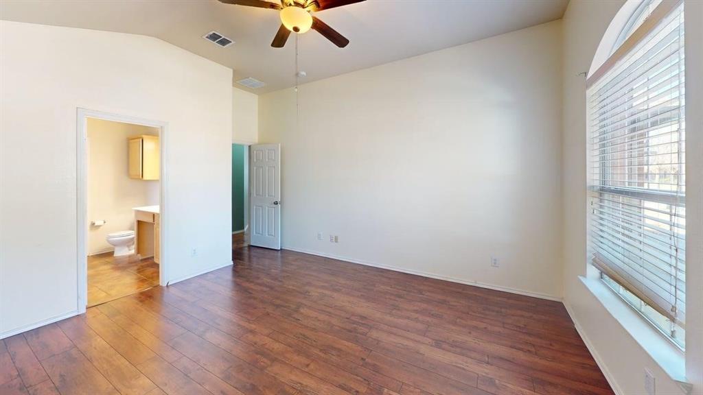 3251 Torio Grand Prairie, TX 75054 - Photo 9 of 23 an empty room with wooden floor and windows