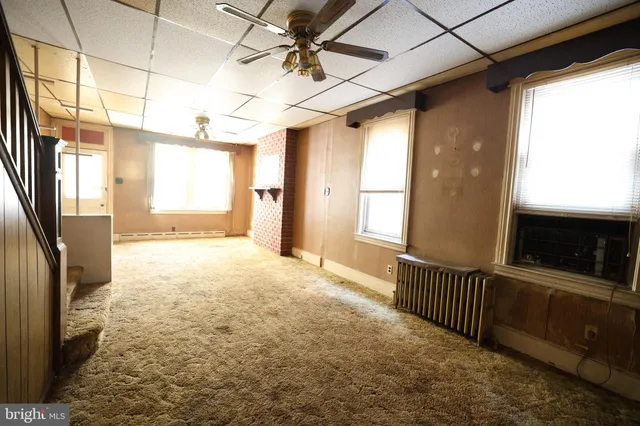 a view of an empty room with a fireplace
