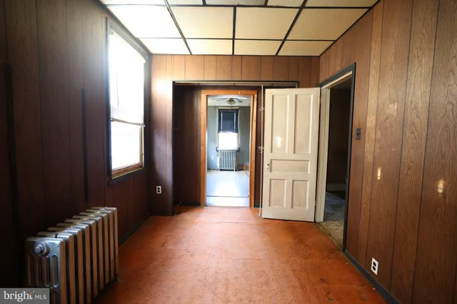 a view of a room with wooden floor and windows