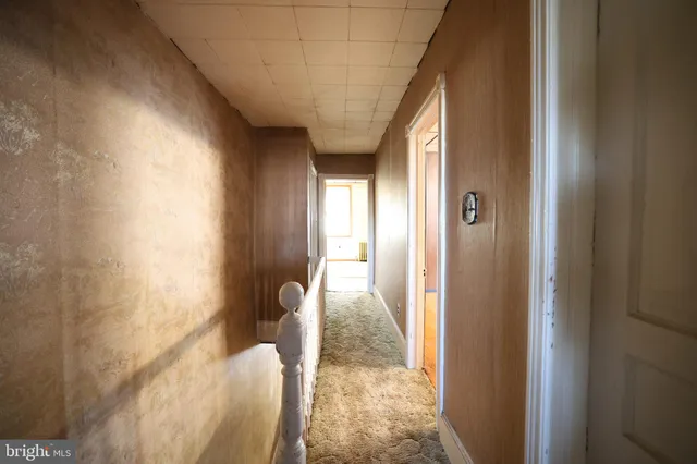 a view of a hallway with wooden floor and entryway