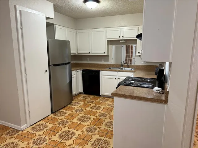 a kitchen with a stove and a refrigerator