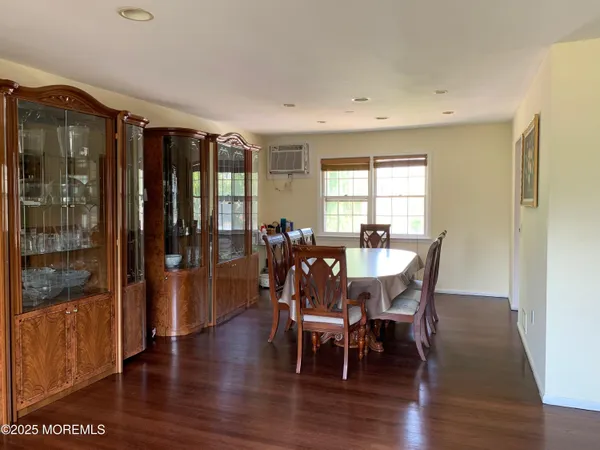 a view of a a dining room with furniture window and wooden floor