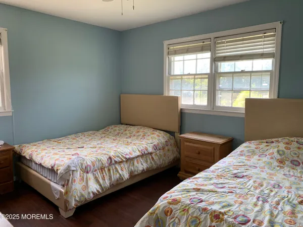 a bedroom with two beds and a window