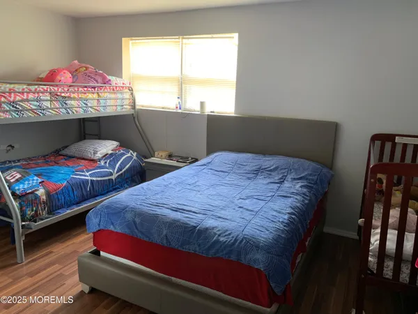 a bedroom with two beds and a window