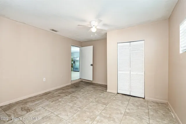 an empty room with an entryway and shower