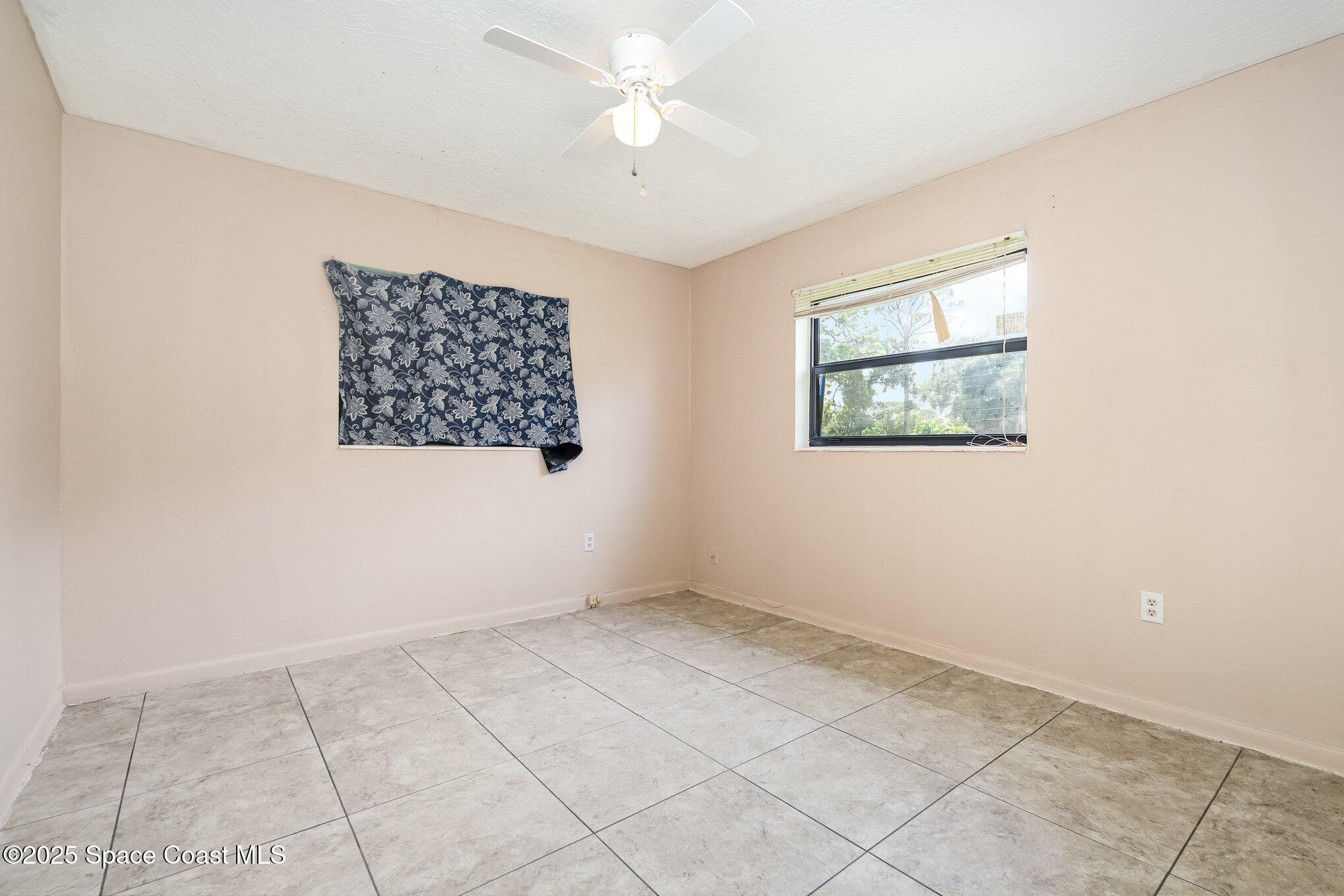 935 South Varr Avenue Rockledge, FL 32955 - Photo 17 of 29 an empty room with windows and fan