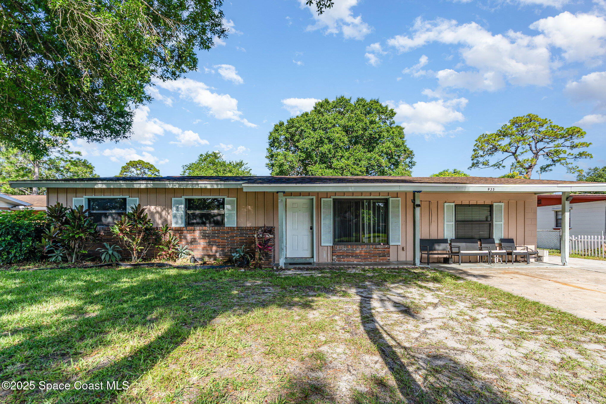 935 South Varr Avenue Rockledge, FL 32955 - Photo 2 of 29 a front view of house with yard outdoor seating and green space