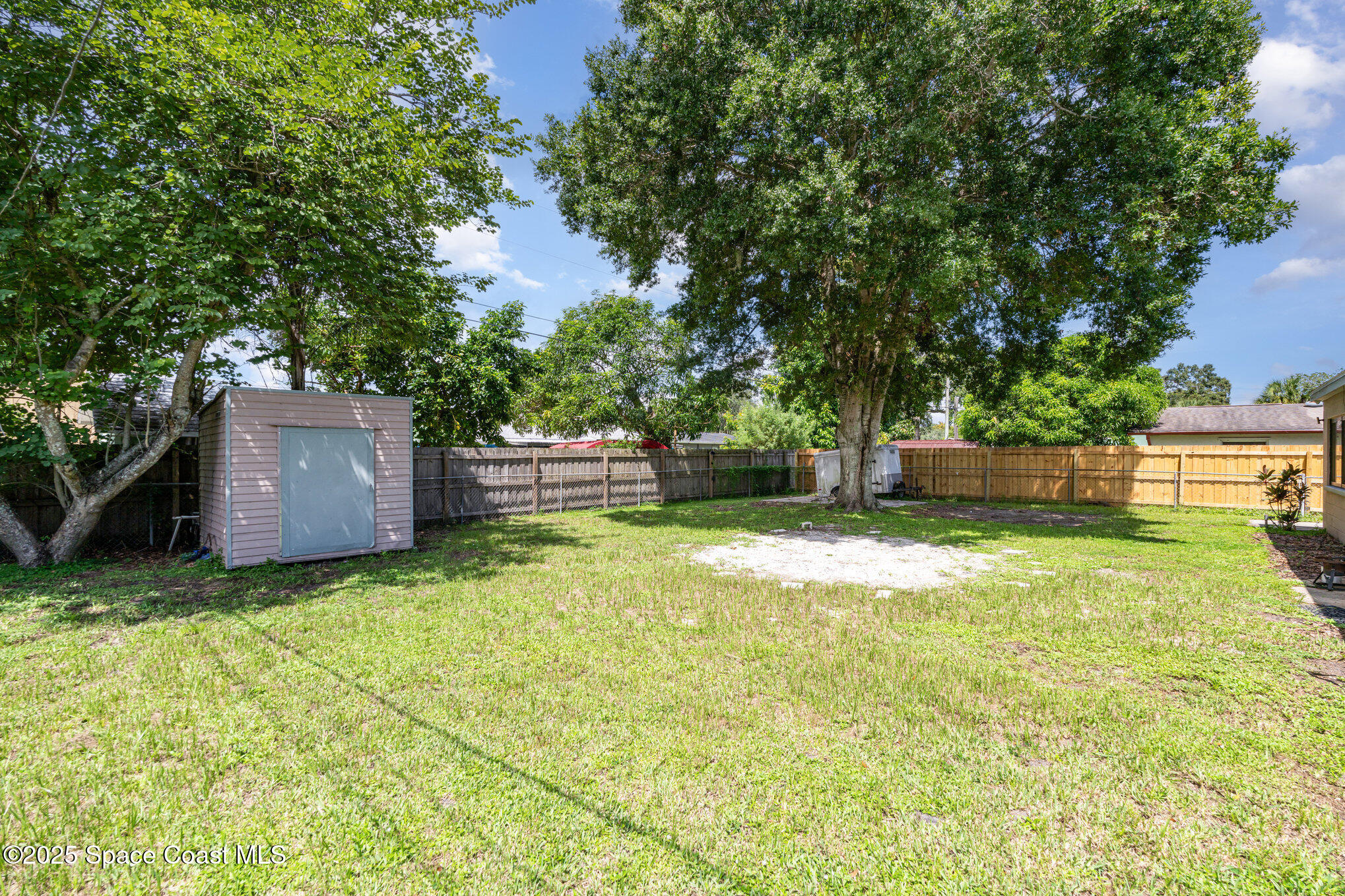 935 South Varr Avenue Rockledge, FL 32955 - Photo 26 of 29 a backyard of a house with a garden and tree