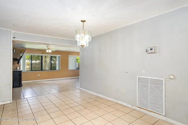 a view of an empty room with glass door