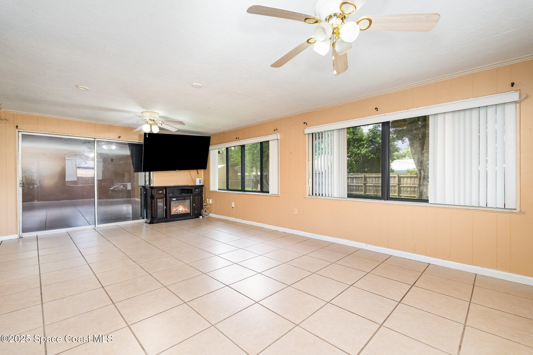 935 South Varr Avenue Rockledge, FL 32955 - Photo 10 of 29 a view of an empty room with a fireplace and a window