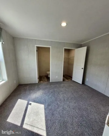 an empty room with a window and a fireplace