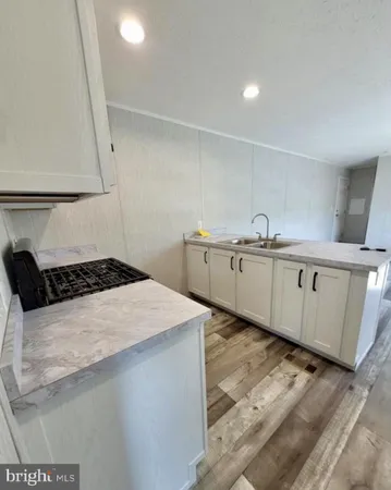 a kitchen with a sink a stove and cabinets