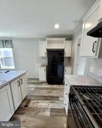 a kitchen with granite countertop a stove and a sink