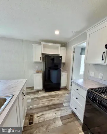 a kitchen with a stove and a refrigerator