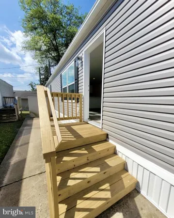 a view of a patio with table and chairs with wooden floor and fence