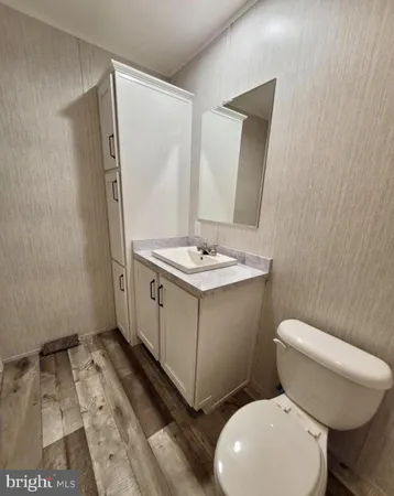 a white toilet sitting next to a bathroom sink