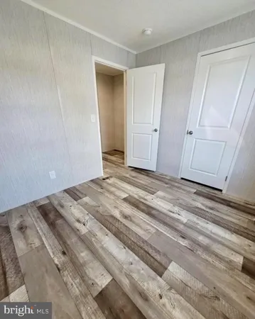 a view of a closet area with wooden floor