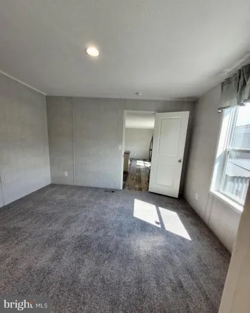 an empty room with a fireplace and windows