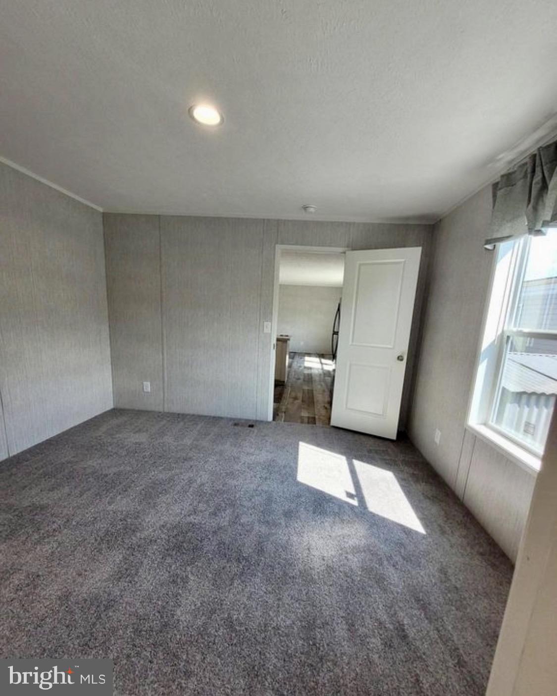 47 Hilltop Avenue Akron, PA 17501 - Photo 7 of 29 an empty room with a fireplace and windows