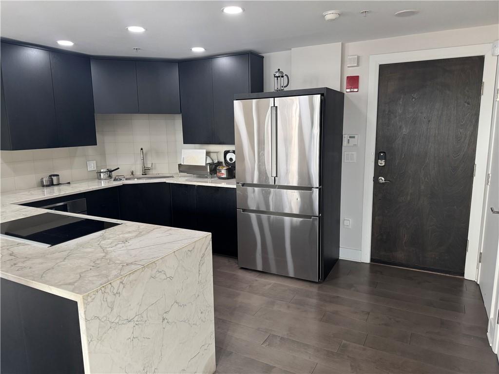 306 Fourth Avenue, Unit 1602 Pittsburgh, PA 15222 - Photo 11 of 31 a kitchen with stainless steel appliances a refrigerator a sink a stove a microwave and cabinets