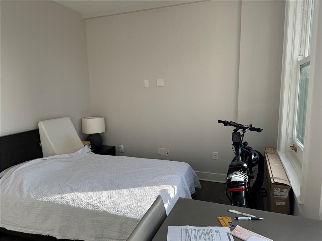 306 Fourth Avenue, Unit 1602 Pittsburgh, PA 15222 - Photo 19 of 31 a bedroom with a bed and a table