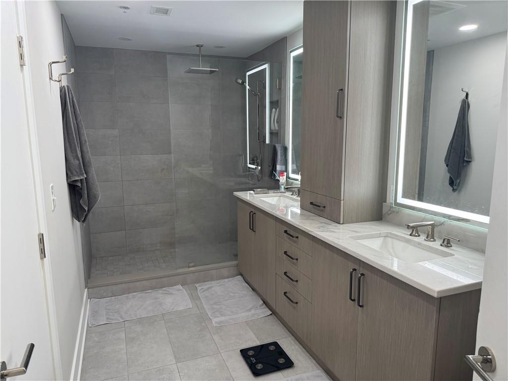 306 Fourth Avenue, Unit 1602 Pittsburgh, PA 15222 - Photo 22 of 31 a bathroom with a double vanity sink mirror and shower