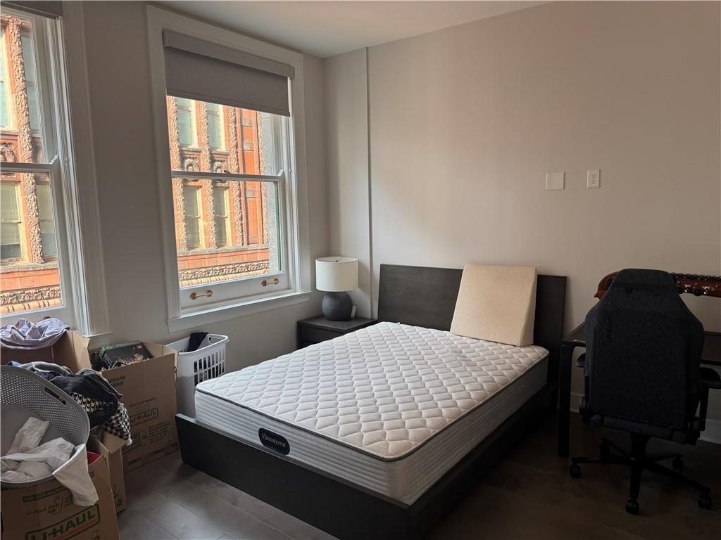 306 Fourth Avenue, Unit 1602 Pittsburgh, PA 15222 - Photo 25 of 31 a bedroom with a bed window and chair