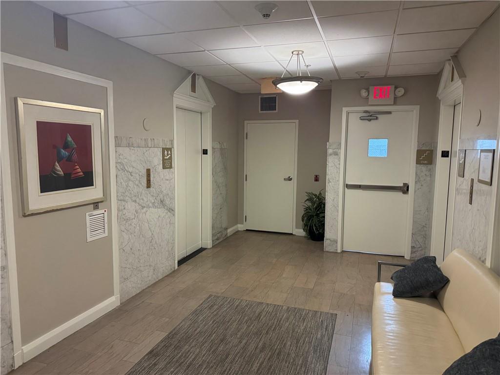 306 Fourth Avenue, Unit 1602 Pittsburgh, PA 15222 - Photo 7 of 31 en empty room with wooden floor and windows