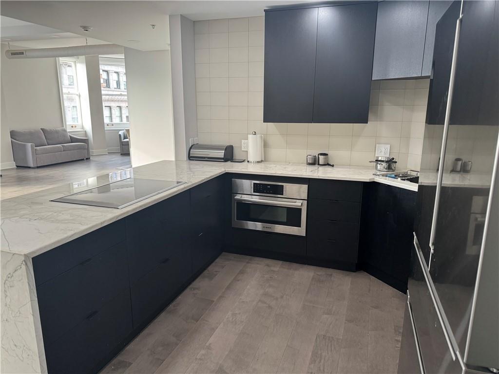 306 Fourth Avenue, Unit 1602 Pittsburgh, PA 15222 - Photo 10 of 31 a kitchen with stainless steel appliances granite countertop a sink stove and refrigerator