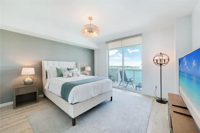 a bedroom with a bed and a large window