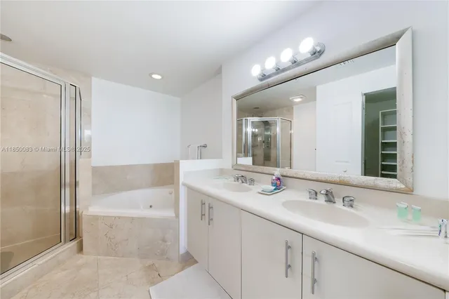 a bathroom with a sink double vanity and a mirror