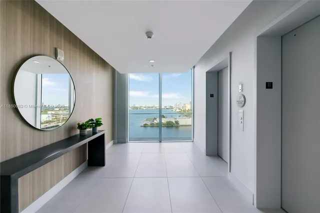 a lobby with furniture and a mirror