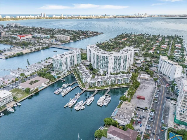 an aerial view of a house with a garden and lake view