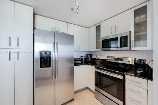 a kitchen with stainless steel appliances a refrigerator stove and microwave