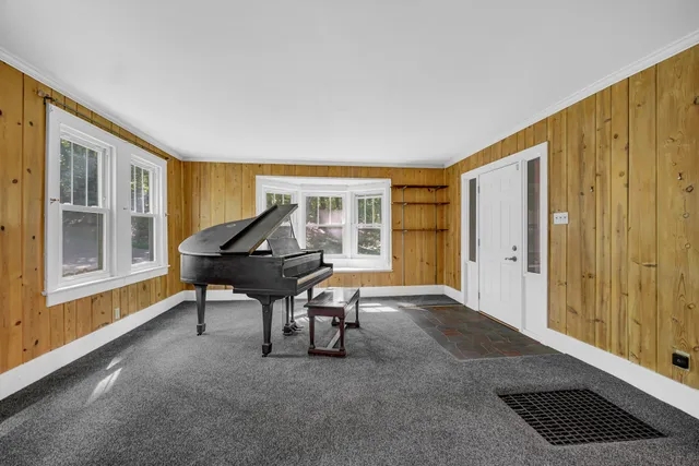 a workspace room with furniture and a window
