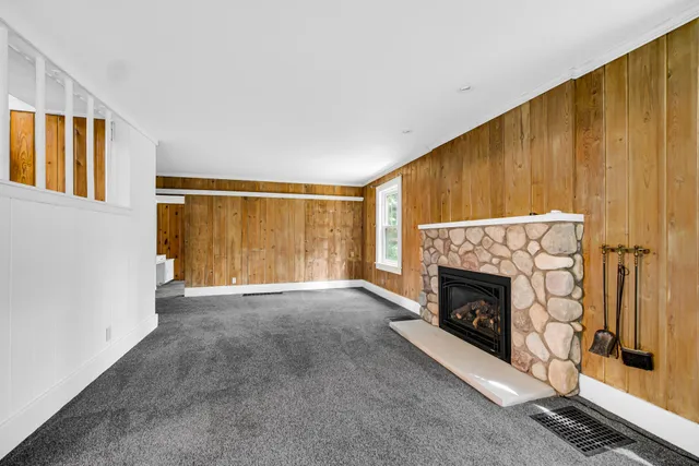 a view of an empty room with a fireplace