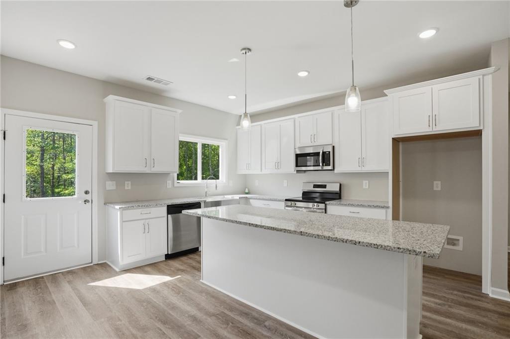 314 Coady Road Jackson, GA 30233 - Photo 17 of 31 a kitchen with stainless steel appliances granite countertop a sink stove and refrigerator