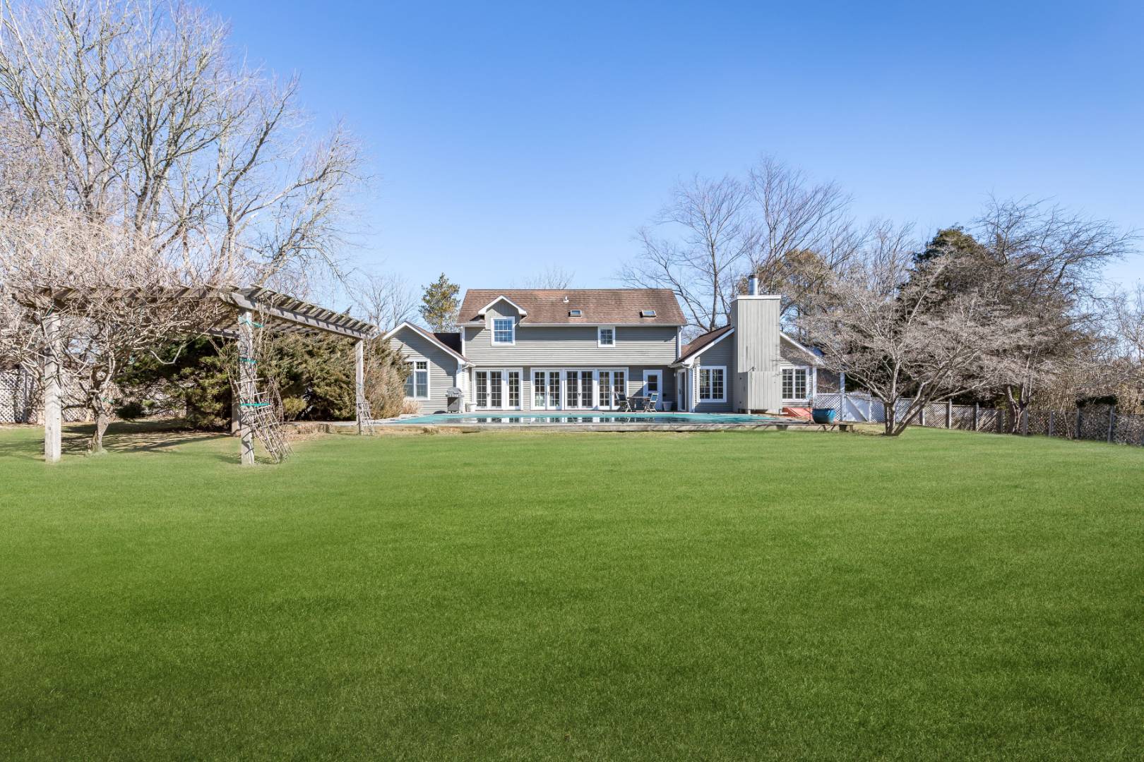 40 Williams Way Bridgehampton, NY 11932 - Photo 2 of 17 a view of a big house with a big yard and large trees