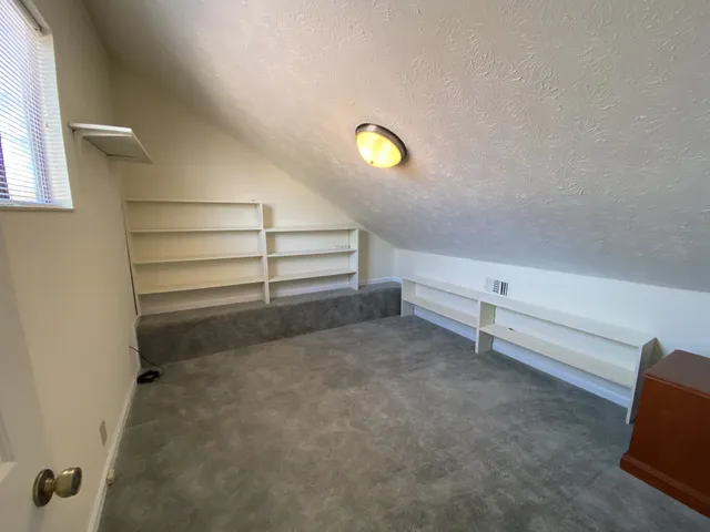 a view of room with stairs and a rug