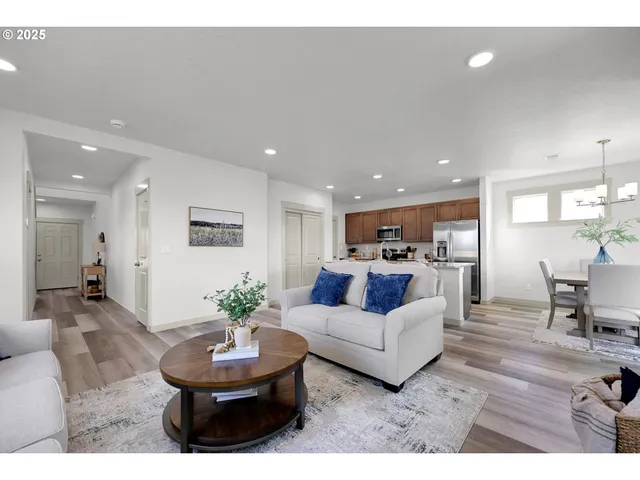 a living room with furniture kitchen and a table